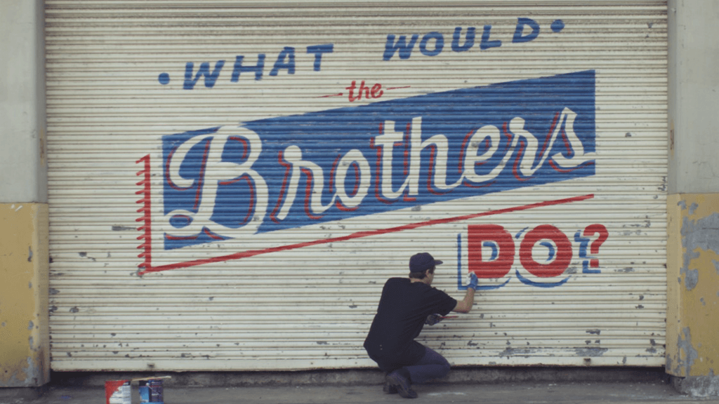 A mural that says "What would the brothers do?"